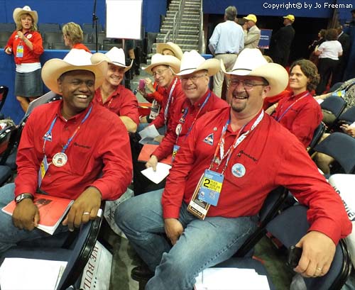 Delegates wear red shirts and cowboy hats
