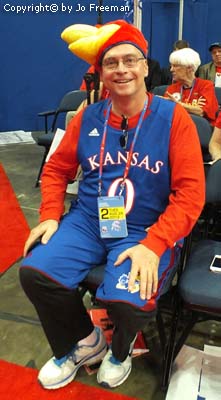 a man wears a mascot costume of a Kansas sports team