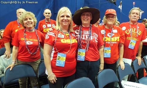 Delegates wear red Chiefs sports shirts.
